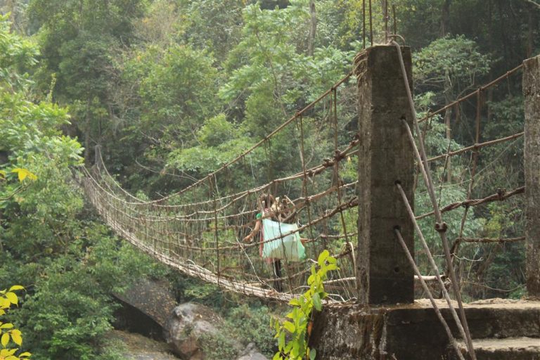 Crossing a steel bridge above Mawsaw river